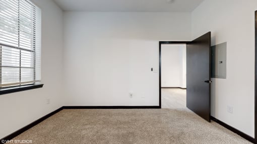 a bedroom with white walls and a door to a closet at Bristol On Union Apartment Homes, Tennessee, 38104