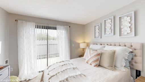 a bedroom with a large bed and a window at Karric Place of Dublin Apartments, Ohio, 43016