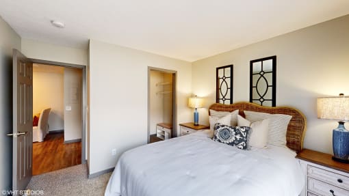 a bedroom with a large bed and a closet at Springburne at Polaris Apartments, Columbus