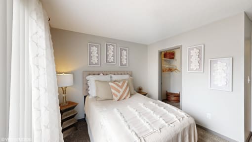a bedroom with a white bed and white curtains at Karric Place of Dublin Apartments, Dublin, Ohio