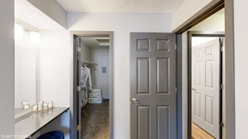 a bedroom with a closet and a door to a bathroom at Silvertree at Little Turtle Apartments, Westerville