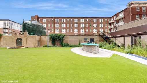 Courtyard BBQ Grill and fountain at 275 on the Park Apartments, St. Louis, 63108