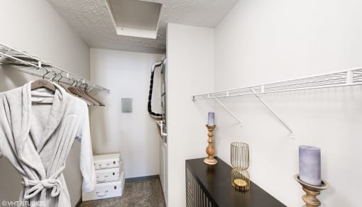 a walk in closet with a dresser and a rack of clothes in a room at Silvertree at Little Turtle Apartments, Ohio, 43081
