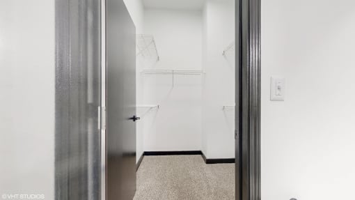a walk in closet in a white room with a silver door at Bristol On Union Apartment Homes, Memphis, TN, 38104