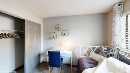 a bedroom with a desk and a bed and a closet at Silvertree at Little Turtle Apartments, Ohio, 43081