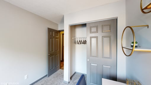 an empty hallway with a closet and a door to a bathroom at Silvertree at Little Turtle Apartments, Westerville, OH