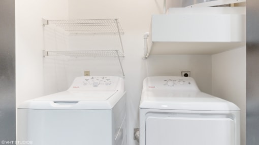 a laundry room with two washes and a dryer at Bristol On Union Apartment Homes, Tennessee