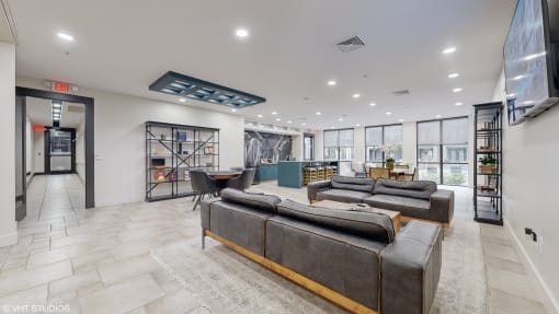 a large living room with couches and a table in the middle at Bristol On Union Apartment Homes, Memphis, TN