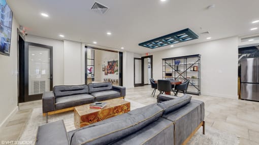 a living room with two couches and a coffee table in front of a kitchen at Bristol On Union Apartment Homes, Memphis, Tennessee