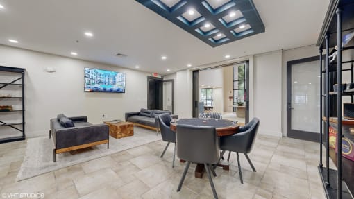 community room with card table and chairs and a tv on the wall at Bristol On Union Apartment Homes, Memphis