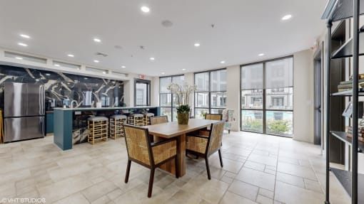 community dining room with a table and chairs in front of a kitchen at Bristol On Union Apartment Homes, Memphis, Tennessee