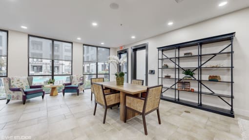 Community dining room with a table and chairs and a shelf at Bristol On Union Apartment Homes, Tennessee, 38104