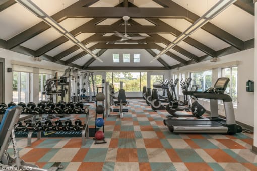 a gym with weights and cardio equipment in a large room with windows at Runaway Bay Apartments, Ohio, 43204
