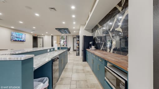 a large kitchen with blue cabinets and marble counter tops at Bristol On Union Apartment Homes, Memphis, TN, 38104