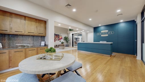 a kitchen and dining area with a blue wall and wood floors at Bristol On Union Apartment Homes, Memphis, TN, 38104