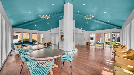 A large room with a round table and chairs.