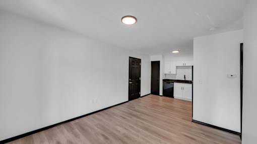 A room with a wooden floor and white walls. at The District Apartments, Tennessee
