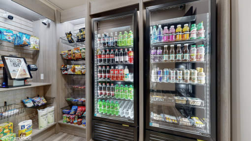 the refrigerator is stocked with soda and other drinks in the pantry at Bristol On Union Apartment Homes, Memphis, TN