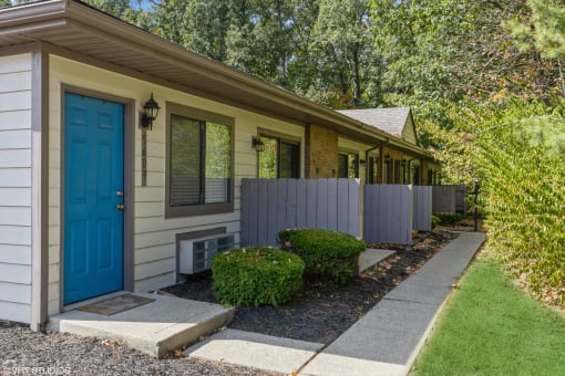 a blue door on the side of a house at Silvertree at Little Turtle Apartments, Westerville, Ohio