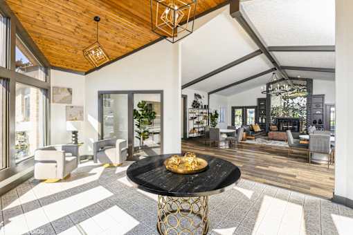 A modern living room with a black marble table in the center at Karric Place of Dublin Apartments, Dublin, OH, 43016