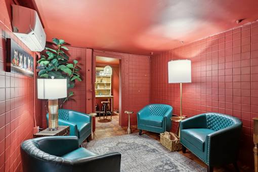 A room with red walls and blue chairs.
