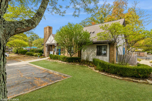 a small house with a driveway and lawn in front of it at Silvertree at Little Turtle Apartments, Westerville, OH