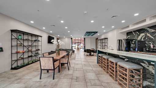 A modern kitchen with a dining table and chairs.
