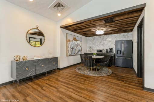 a kitchen and dining room with a black refrigerator and a table and chairs at Springburne at Polaris Apartments, Ohio