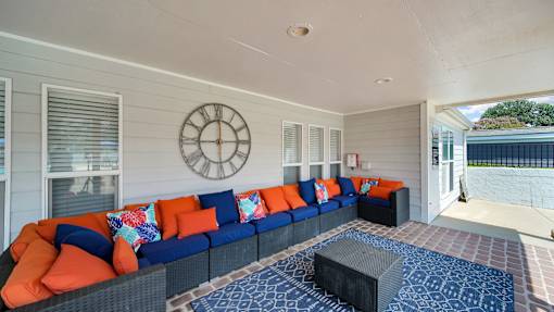 A patio with a couch and a table. at The Stella Apartments, Memphis
