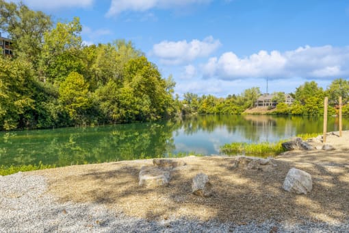 a view of a lake with a house in the background at Runaway Bay Apartments, Columbus, OH