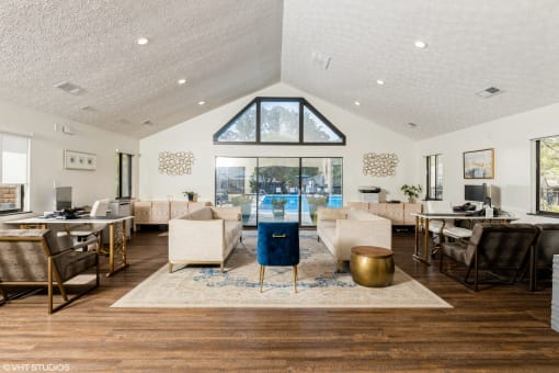 a living room with a vaulted ceiling and a view of a pool at Silvertree at Little Turtle Apartments, Westerville, 43081