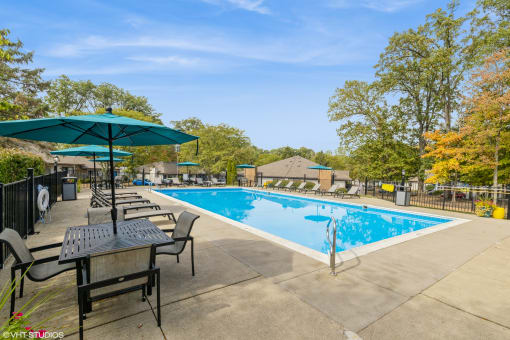 our apartments have a swimming pool with chairs and tables at Silvertree at Little Turtle Apartments, Westerville, OH