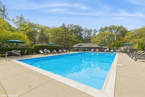 a swimming pool with chairs and umbrellas at the resort on a sunny day at Silvertree at Little Turtle Apartments, Ohio, 43081