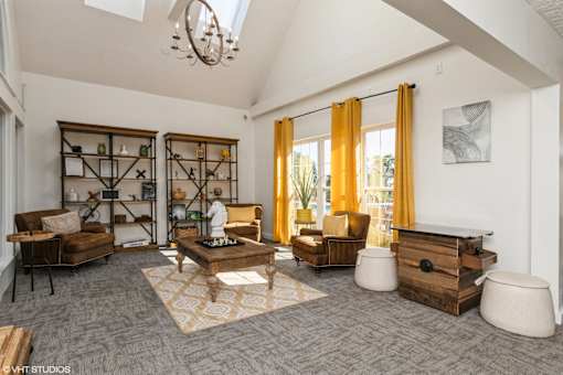 A living room with a grey carpet and wooden furniture at Island Club Apartments, Columbus