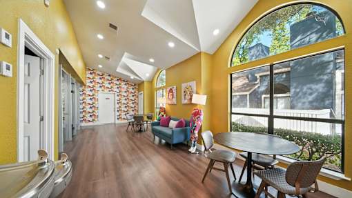 A yellow hallway with a table and chairs.