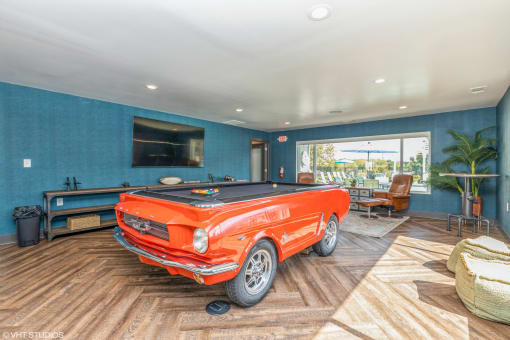 a pool table in a living room with a orange truck in the middle at Runaway Bay Apartments, Columbus, OH
