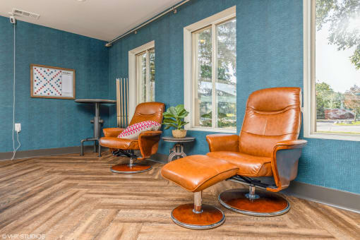 a living room with two leather chairs and a wood floor at Runaway Bay Apartments, Columbus, Ohio
