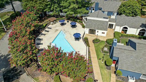 A house with a pool surrounded by trees.