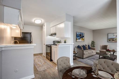 a living room and kitchen with a table and chairs at Tara Oaks in Houston, TX