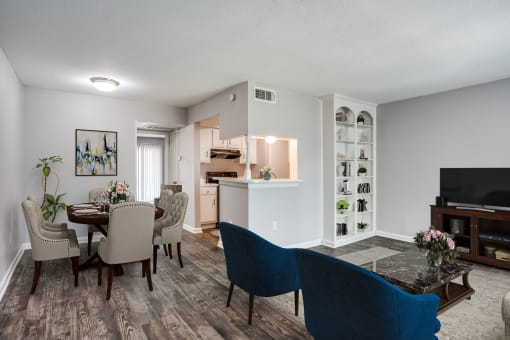 a living room and dining room with a table and chairs at Tara Oaks in Houston, TX