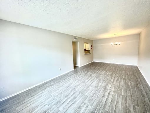an empty living room with wood floors and white walls at Cambridge Village Apartments, Houston, TX ? 