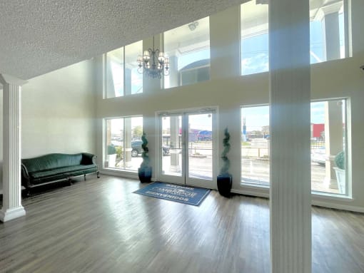 an empty living room with a couch and a chandelier at Cambridge Village Apartments, Houston, 77045 ? 