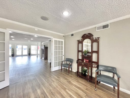 an empty living room with a wood floor and white walls at Cambridge Village Apartments, Houston, TX 77045 ? 