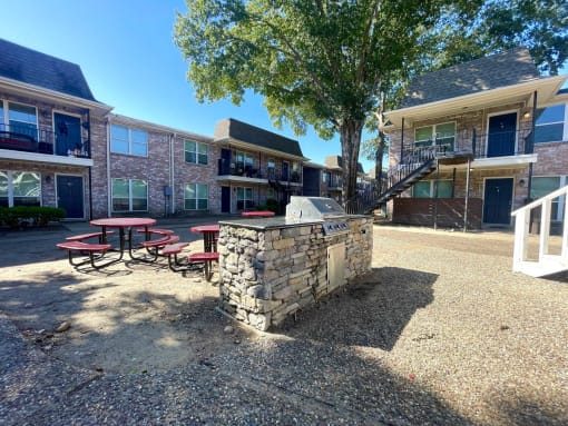 our apartments have a spacious courtyard with a grill and picnic table at Tara Oaks in Houston, TX