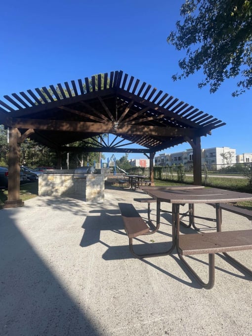a picnic area with a picnic table and a pavilion at Whispering Oaks, Conroe ? 