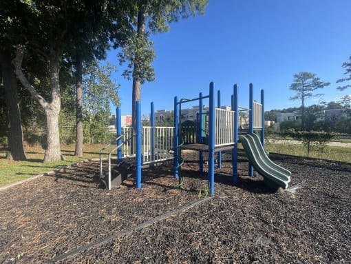 a playground with slides and benches in a park at Whispering Oaks, Conroe, TX ? 