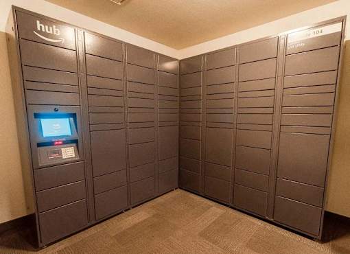 A row of lockers with a computer screen on the left at Ellyson Apartment Homes, Tacoma, Washington