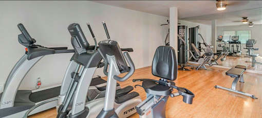 A gym with treadmills and other exercise equipment.