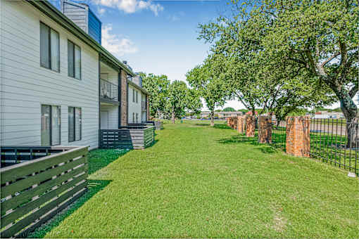 A grassy area in front of apartment buildings at Water Ridge Apartments , Irving, 75061