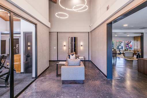 A modern living room with a marble floor and a large white sofa at Water Ridge Apartments , Texas, 75061